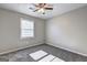 Bedroom featuring gray carpet, neutral walls, ceiling fan and a window at 5495 Reynolds Rd, Morrow, GA 30260