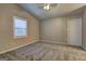 Spacious bedroom with a ceiling fan, neutral carpeting, and a window at 5495 Reynolds Rd, Morrow, GA 30260