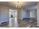 Open-concept dining area showcasing a chandelier and flowing into the kitchen and living spaces at 5495 Reynolds Rd, Morrow, GA 30260