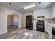 Spacious kitchen equipped with black appliances, white cabinets, and modern wood floors at 5495 Reynolds Rd, Morrow, GA 30260