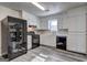 Modern kitchen features black appliances, white cabinets, and gray wood flooring at 5495 Reynolds Rd, Morrow, GA 30260