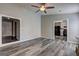 Open-concept living area with stylish gray wood floors, leading to other rooms in the home at 5495 Reynolds Rd, Morrow, GA 30260