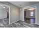 Open living space with stylish gray wood floors and views into other rooms at 5495 Reynolds Rd, Morrow, GA 30260