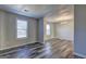 Bright living room featuring gray wood-look flooring and a decorative light fixture at 5495 Reynolds Rd, Morrow, GA 30260