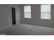 Spacious bedroom with neutral paint, carpet flooring, and bright windows at 358 Southgate Dr, Locust Grove, GA 30248