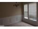 The dining room has carpet flooring, white trim, and a large window for natural light at 358 Southgate Dr, Locust Grove, GA 30248