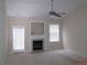 Cozy living room features a fireplace, ceiling fan, and lots of natural light at 358 Southgate Dr, Locust Grove, GA 30248