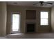 Cozy living room features a fireplace, ceiling fan, and lots of natural light at 358 Southgate Dr, Locust Grove, GA 30248