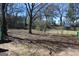 Large backyard with chain link fence and mature trees at 343 Kate Dr, Forest Park, GA 30297