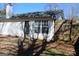 Fenced backyard with door, window, and small patio area at 343 Kate Dr, Forest Park, GA 30297