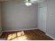 Bedroom featuring hardwood flooring, a ceiling fan, and a closet with sliding doors at 343 Kate Dr, Forest Park, GA 30297