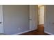 Neutral bedroom with light wood floors and two white doors at 343 Kate Dr, Forest Park, GA 30297