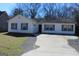 Quaint single-story home with a driveway and white siding and blue shutters at 343 Kate Dr, Forest Park, GA 30297