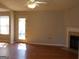 Bright living room featuring hardwood floors, a fireplace, and a ceiling fan at 343 Kate Dr, Forest Park, GA 30297