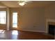 Bright living room featuring hardwood floors, a fireplace, and a ceiling fan at 343 Kate Dr, Forest Park, GA 30297