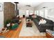 Spacious living room with a stone-look accent wall, hardwood floors and a comfortable sectional couch at 888 Laney Rd, Locust Grove, GA 30248