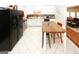 Bright eat-in kitchen features white cabinets, stainless appliances, and tile flooring at 888 Laney Rd, Locust Grove, GA 30248