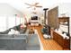 Inviting living room featuring a stone accent wall, wood-burning stove, and a plush sectional couch at 888 Laney Rd, Locust Grove, GA 30248