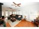Bright living room with a sectional couch, hardwood floors, and large windows at 888 Laney Rd, Locust Grove, GA 30248