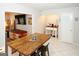 Bright eat-in kitchen with dining area and coffee bar features white cabinets, stainless appliances, and tile flooring at 888 Laney Rd, Locust Grove, GA 30248