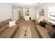 Neutral living room featuring two couches, plush carpet, and a decorative built-in cabinet at 888 Laney Rd, Locust Grove, GA 30248