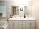 This bathroom features neutral colors, a double-sink vanity, and a jetted tub at 888 Laney Rd, Locust Grove, GA 30248