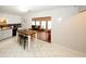Cozy kitchen with white cabinets, a breakfast table, and an opening to the living room at 888 Laney Rd, Locust Grove, GA 30248
