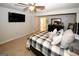 Comfortable bedroom featuring a ceiling fan, TV, and closet at 888 Laney Rd, Locust Grove, GA 30248