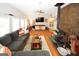 Open living room with hard wood floors, a wood-burning stove, and comfortable sectional couch at 888 Laney Rd, Locust Grove, GA 30248