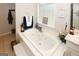 Bright primary bath with tile surround soaking tub and window at 888 Laney Rd, Locust Grove, GA 30248