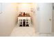Coffee bar features white cabinets, stainless appliances, and tile flooring at 888 Laney Rd, Locust Grove, GA 30248