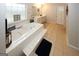 Bright primary bath with tile surround soaking tub and double sink at 888 Laney Rd, Locust Grove, GA 30248