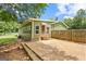 The backyard features a green home, a patio, and partial fencing at 888 Laney Rd, Locust Grove, GA 30248