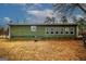 The backyard features a green home, several windows, and a grassy yard at 888 Laney Rd, Locust Grove, GA 30248
