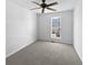 Bedroom features neutral walls, plush carpeting and window providing natural light, offering a cozy retreat at 11403 South Grove Dr, Hampton, GA 30228