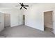 Spacious bedroom with neutral carpet, ceiling fan, and entryways to walk-in closet and bathroom at 11403 South Grove Dr, Hampton, GA 30228