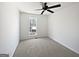 Neutral bedroom with a window view and a ceiling fan at 11403 South Grove Dr, Hampton, GA 30228