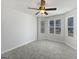 Bright bedroom features neutral walls, fan with light, three windows allowing for lots of natural light and grey plank flooring at 11403 South Grove Dr, Hampton, GA 30228