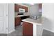 Functional kitchen with a breakfast bar, white appliances, and warm wood cabinetry at 11403 South Grove Dr, Hampton, GA 30228
