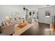 Bright staged living room with large bay window, elegant decor, and dark wood flooring at 11403 South Grove Dr, Hampton, GA 30228