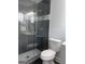 Modern bathroom with tiled shower, glass door, and neutral color scheme at 1066 Ashby Sw Grv, Atlanta, GA 30314