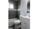 Modern bathroom features gray wall tiles, a white-and-gray mosaic border, and a shower-over-tub at 1066 Ashby Sw Grv, Atlanta, GA 30314