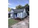 Charming single Gathering home with a blue front door and well manicured front lawn at 1066 Ashby Sw Grv, Atlanta, GA 30314