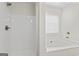 Bright white bathroom showcasing a tub and a separate shower with silver hardware at 11192 Cornerstone Way, Hampton, GA 30228