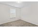 Bedroom with neutral walls, carpeted floor, and bright window bringing in natural light at 11192 Cornerstone Way, Hampton, GA 30228