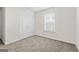 This carpeted bedroom features a window with blinds and double-door closet at 11192 Cornerstone Way, Hampton, GA 30228