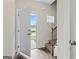 Welcoming foyer with hardwood floors, a staircase, and ample natural light streaming through the open doorway at 11192 Cornerstone Way, Hampton, GA 30228