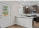 Well lit kitchen offers dark wood cabinets, granite countertops, stainless appliances, hardwood floors and back door access at 11192 Cornerstone Way, Hampton, GA 30228