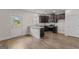 Modern kitchen featuring stainless appliances, dark wood cabinets, granite counters, and a door to the outside at 11192 Cornerstone Way, Hampton, GA 30228