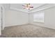 Main bedroom offers neutral carpet, white trim and walls, trey ceiling, ceiling fan and natural light at 11192 Cornerstone Way, Hampton, GA 30228